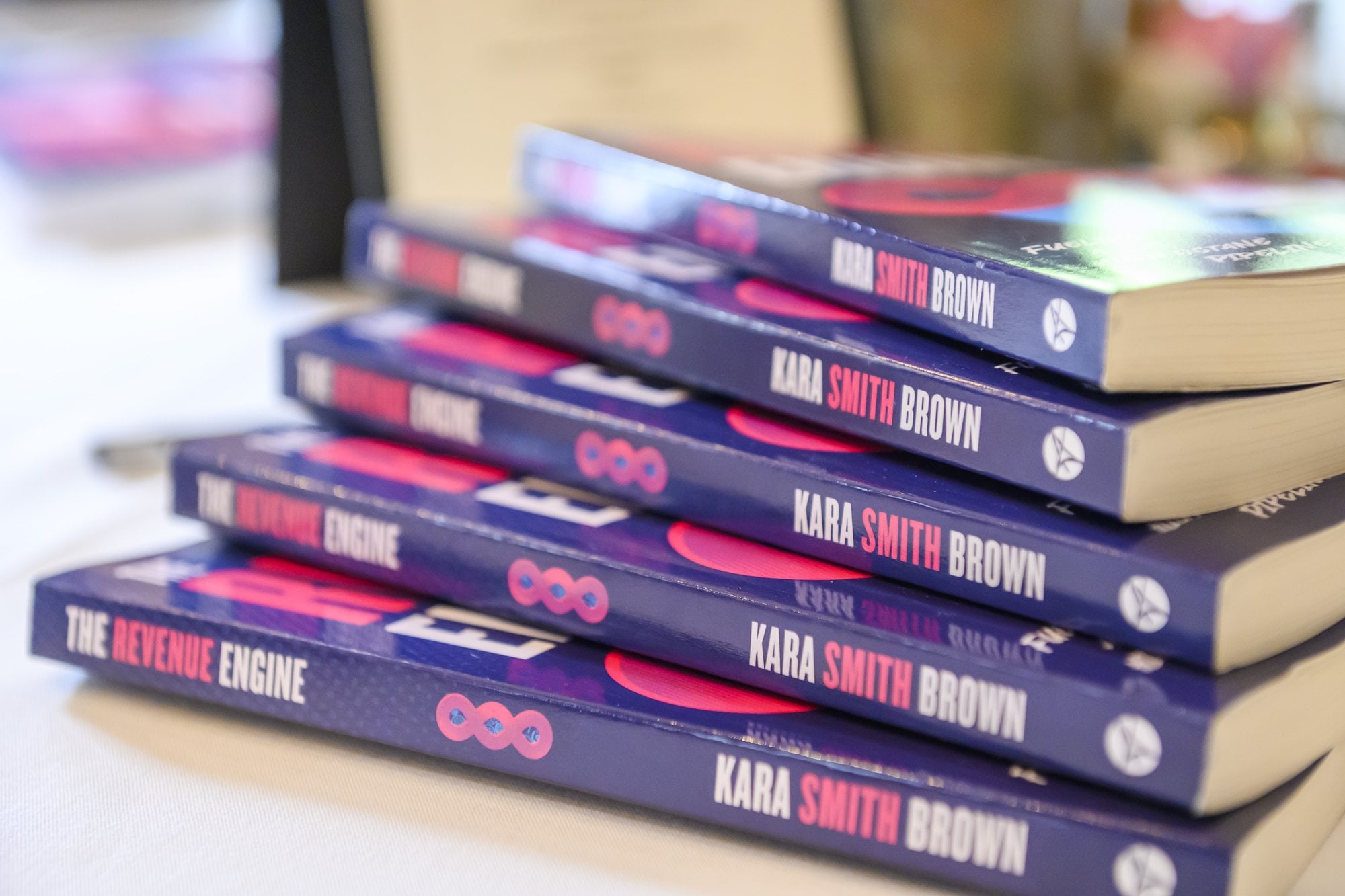 A stack of The Revenue Engine paperbacks at the workshop